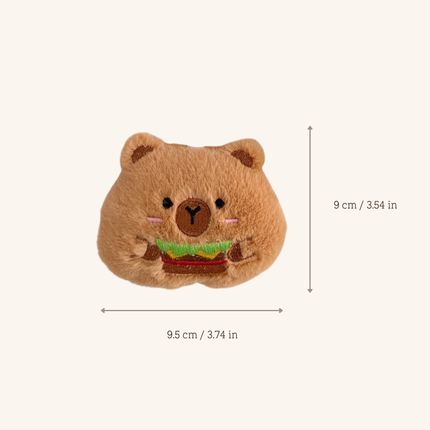 A small plush bear head accessory holding a hamburger, shown on a plain light beige background with measurement arrows and text indicating 9 cm height and 9.5 cm width.
