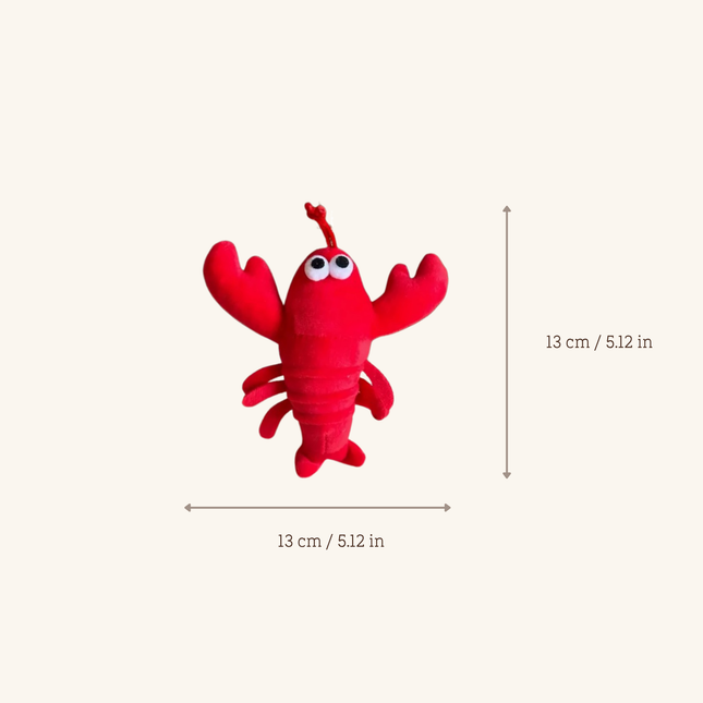 A red lobster-shaped plush toy centered on a light beige background, with measurement arrows and text indicating dimensions of 13 cm by 13 cm (5.12 in by 5.