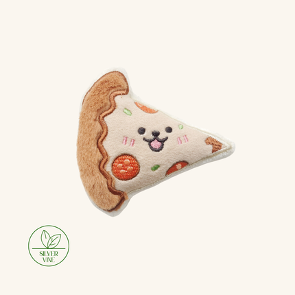 A plush dog toy shaped like a slice of pizza, featuring embroidered details of a smiling face, pepperoni, and green toppings on a cream-colored fabric, shown against a solid off-white background with a 'PREMIUM CANINE' logo in the bottom-left corner.