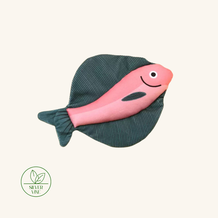A pink fish-shaped bath toy with a dark green ribbed fabric body, shown on a light cream background with a Silver Vine brand logo in the bottom-left corner.