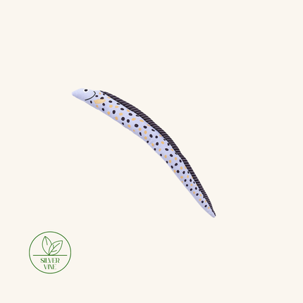 A curved silver eel-shaped hair extension piece with black and gold polka dots and a black dorsal stripe, shown on a plain light beige background with a Silver Vine logo in the lower-left corner.