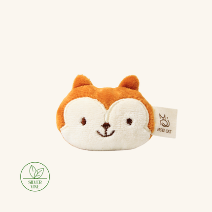 A plush fox face coin purse in orange and cream, featuring embroidered eyes, nose, and mouth, with a 'MINI CAT' brand tag on the side. A green 'SILVER VINE' logo is visible in the bottom-left corner against a solid cream background.